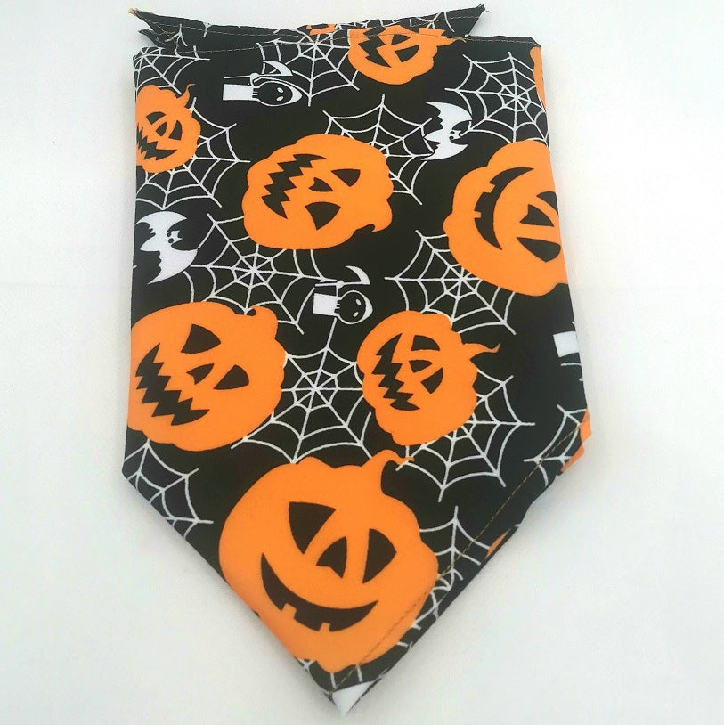 Pet Tie-Dye Triangle Bandana Scarf for Dogs & Cats featuring a Halloween design with orange jack-o'-lanterns, white spider webs, and bats on a black background.