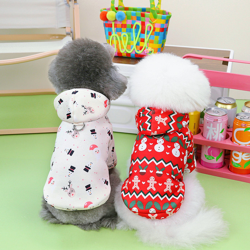 Two small dogs sitting side by side wearing festive holiday clothes, one in a white Dog Christmas Sweatshirt | Festive Holiday Clothes for Dogs with snowmen and Santa faces, the other in a red Dog Christmas Sweatshirt | Festive Holiday Clothes for Dogs with gingerbread men and snowman patterns.