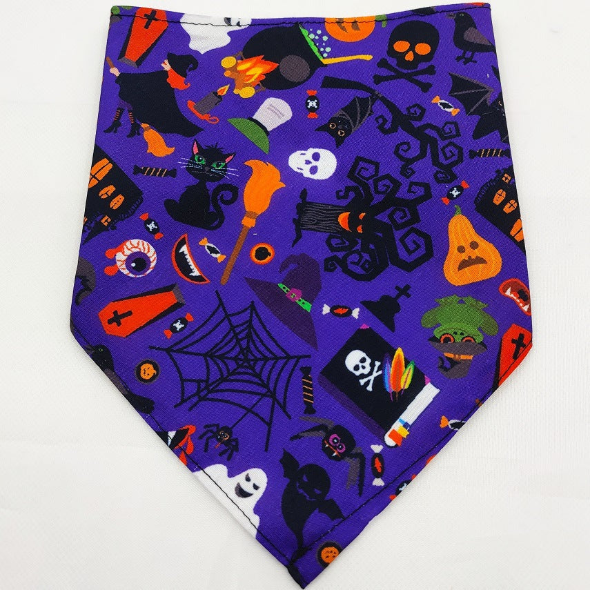 Pet Tie-Dye Triangle Bandana Scarf for Dogs & Cats featuring a vibrant purple Halloween-themed pattern with bats, black cats, ghosts, pumpkins, skulls, and spooky icons for festive dog accessories.