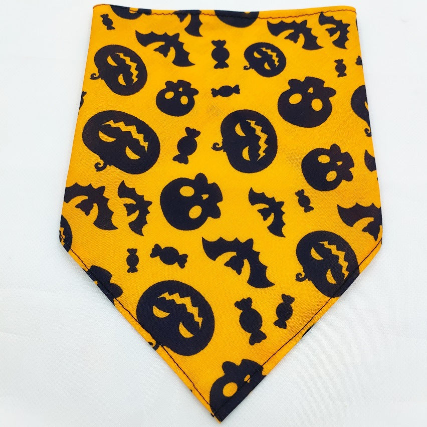 Pet Tie-Dye Triangle Bandana Scarf for Dogs & Cats in bright orange with black Halloween-themed pumpkins, bats, skulls, and candy patterns, perfect dog apparel accessory.